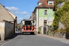 Mähdrescher fährt durch eine Engstelle im Dorf. Für andere Autos oder auch Fußgänger ist kein Platz mehr.